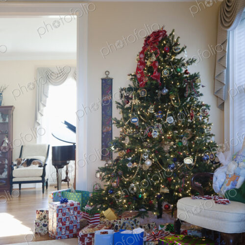 Living room with Christmas tree and gifts, traditional decorations in an American home Living room with Christmas tree and gifts, traditional decorations in an American home