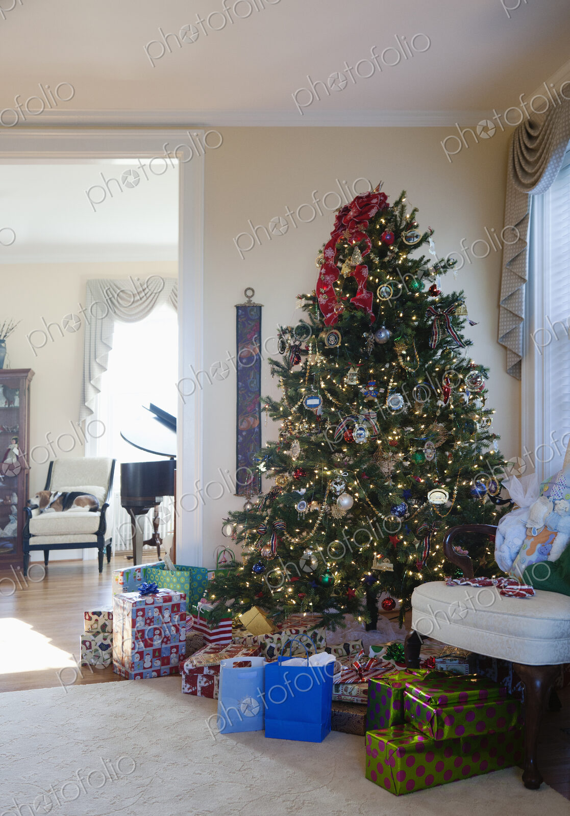 Living room with Christmas tree and gifts, traditional decorations in an American home