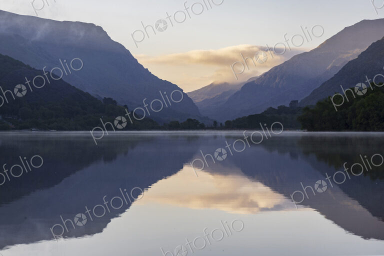 Llyn Padarm, Llanberis, a view across the flat calm waters of the lake with…
