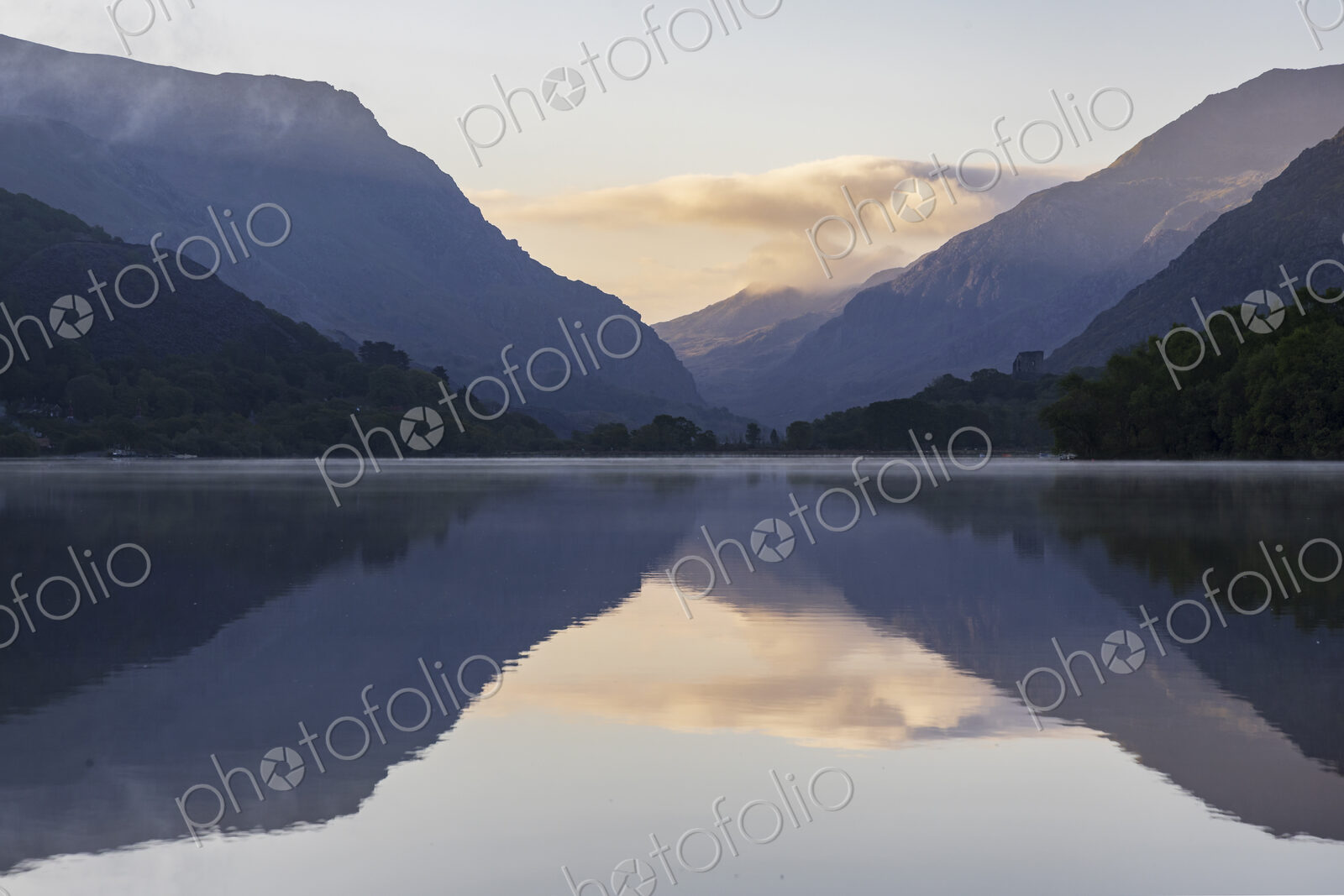 Llyn Padarm, Llanberis, a view across the flat calm waters of the lake with…