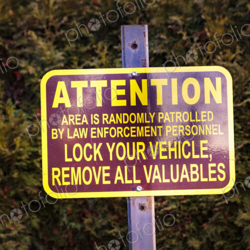 Lock Your Vehicles sign in a public park, Spokane, WA USA Lock Your Vehicles sign in a public park, Spokane, WA USA