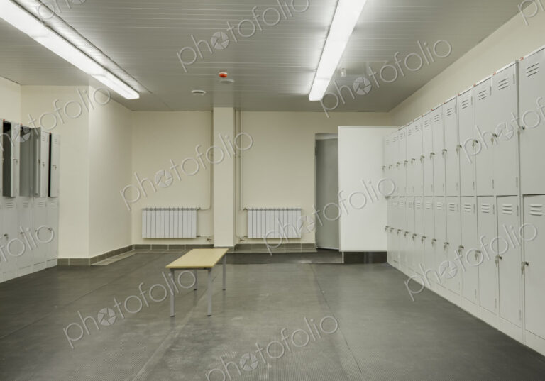 Locker room with rubber mats on floor.