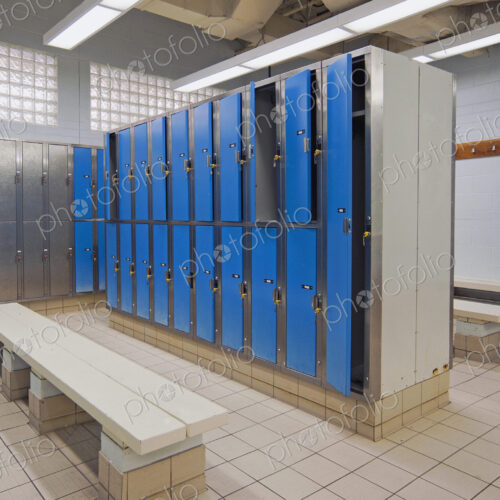 Lockers with blue doors for rent in a public locker room at a recreation centre. Lockers with blue doors for rent in a public locker room at a recreation centre.
