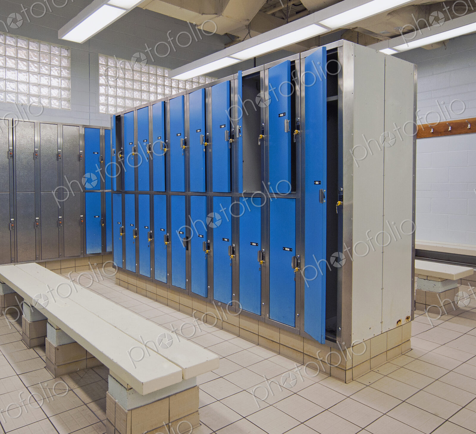 Lockers with blue doors for rent in a public locker room at a recreation centre.