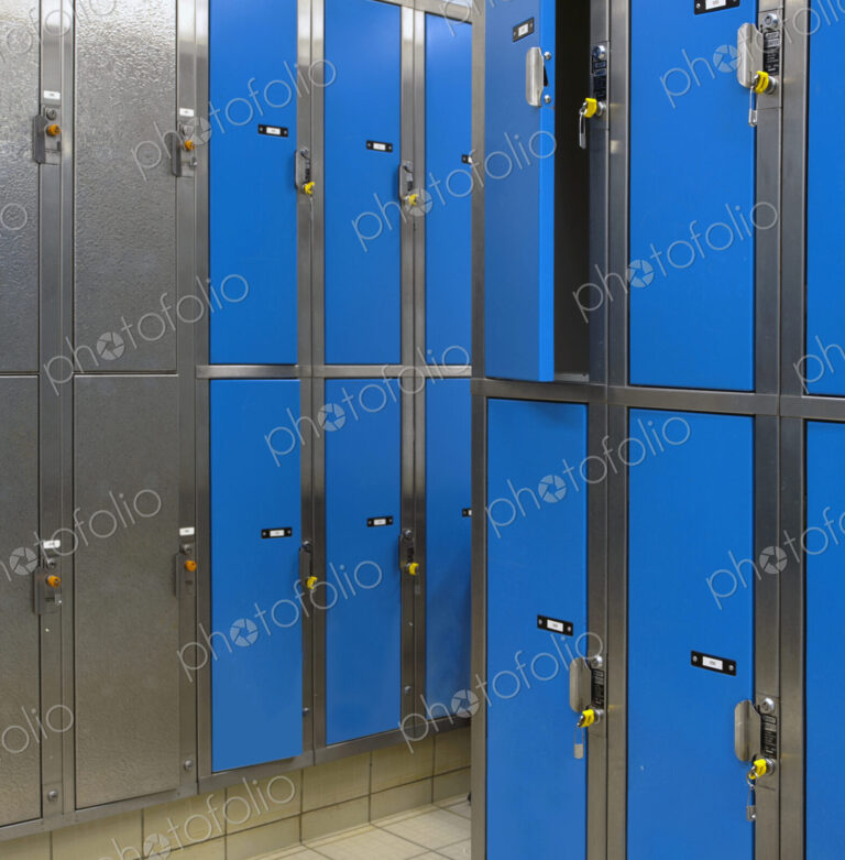 Lockers with blue doors for rent in a public locker room at a recreation centre.