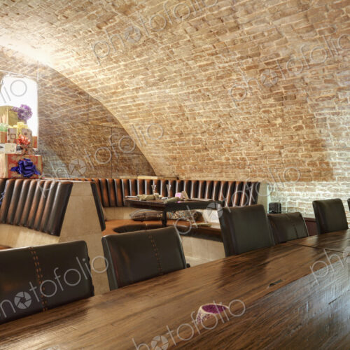 Long wooden table in sports bar.