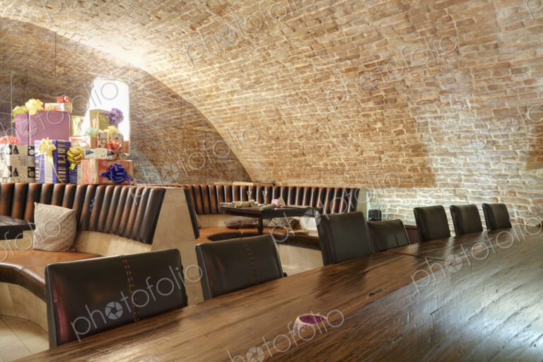 Long wooden table in sports bar.