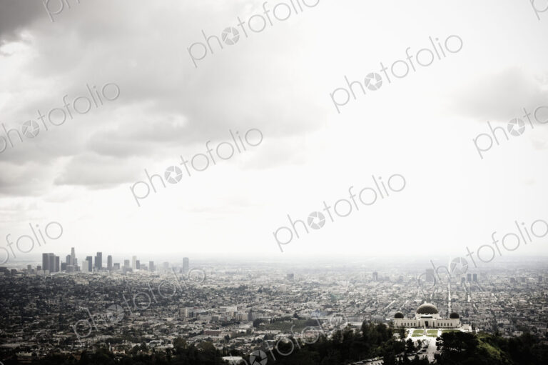 Los Angeles Skyline and Griffith Observatory Beneath Cloudy Sky