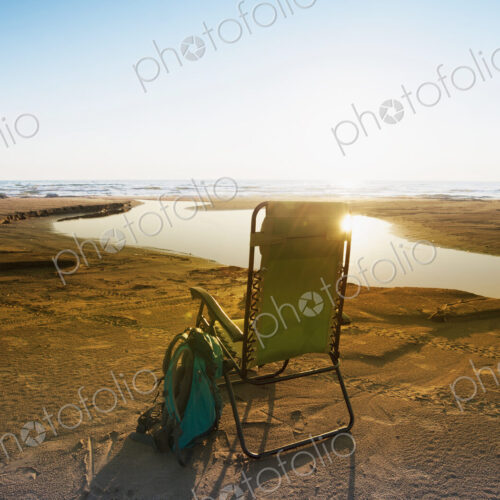 Lounge chair on beach under blue sky Lounge chair on beach under blue sky
