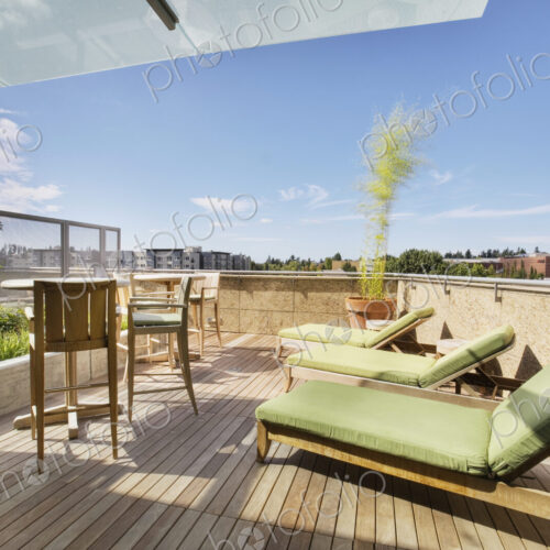 Lounge chairs on rooftop balcony