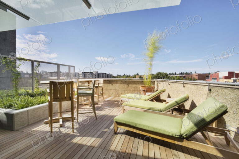 Lounge chairs on rooftop balcony