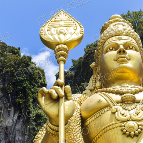 Low angle close up of colossal golden statue of Hindu deity. Low angle close up of colossal golden statue of Hindu deity.