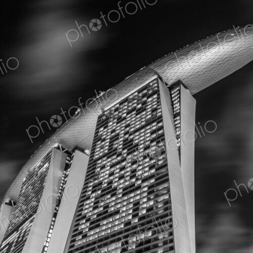 Low angle exterior of Marina Bay Sands Hotel and air bridge connecting three towers. Low angle exterior of Marina Bay Sands Hotel and air bridge connecting three towers.