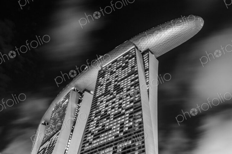 Low angle exterior of Marina Bay Sands Hotel and air bridge connecting three towers.