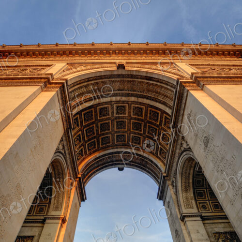 Low angle view of Arc de Triomphe under blue sky, Paris, Ile-de-France, France