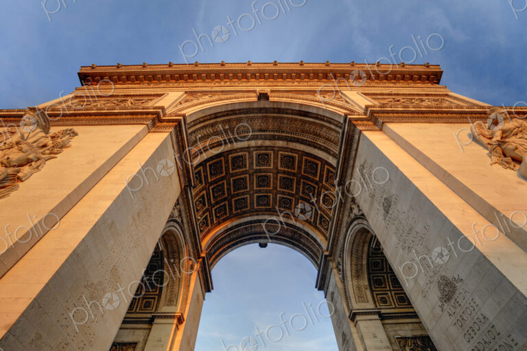 Low angle view of Arc de Triomphe under blue sky, Paris, Ile-de-France, France
