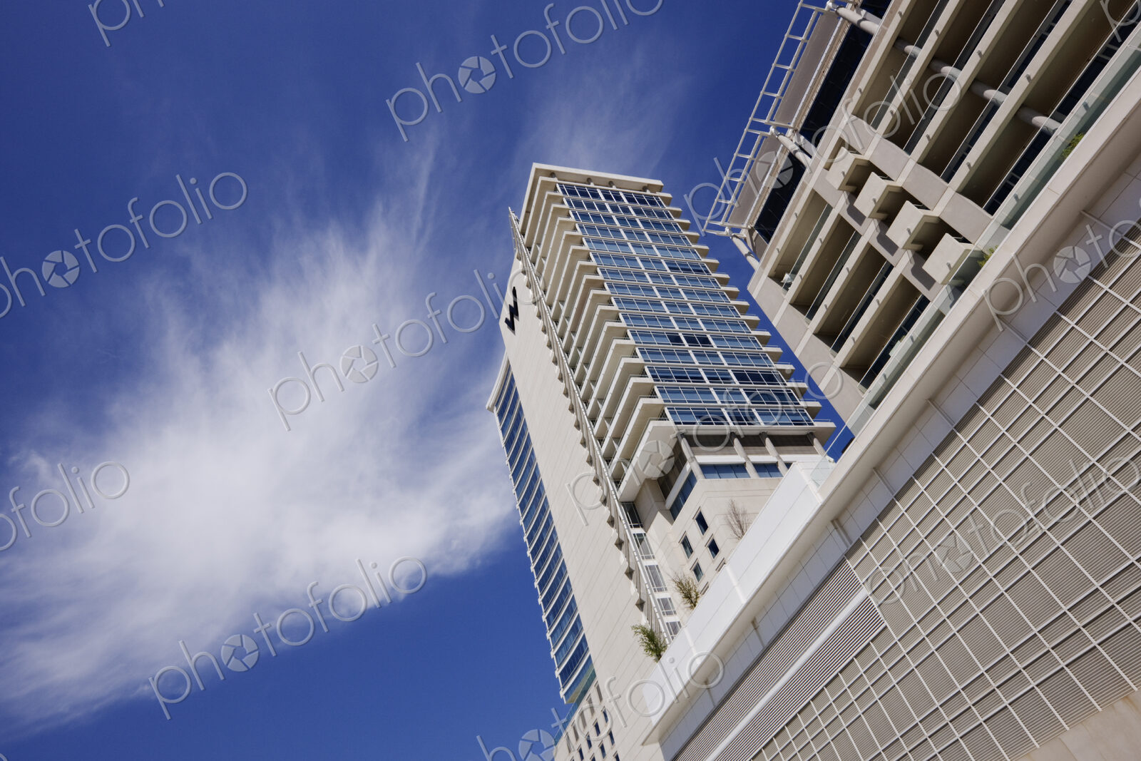Low angle view of apartment building with parking lot.