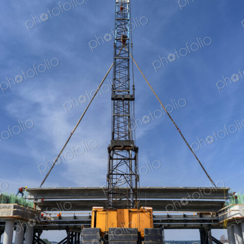 Low angle view of crane and bridge construction