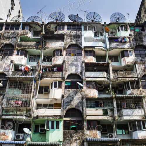 Low angle view of facade of an old apartment building, rows of balconies and windows. Low angle view of facade of an old apartment building, rows of balconies and windows.