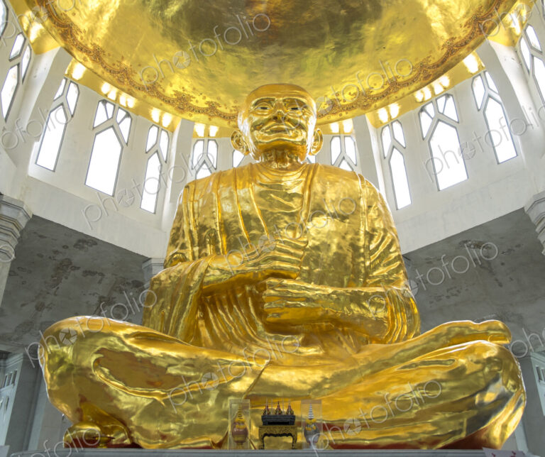 Low angle view of golden Buddha statue in temple, Sikhiu, Nakhon Ratchasima, Thailand
