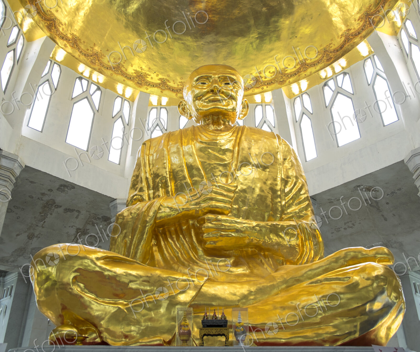 Low angle view of golden Buddha statue in temple, Sikhiu, Nakhon Ratchasima, Thailand