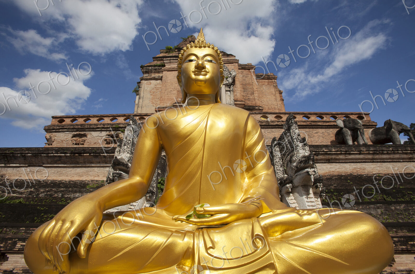 Low angle view of golden Buddha statue outside temple, Chiang Mai, Chiang Mai, Thailand