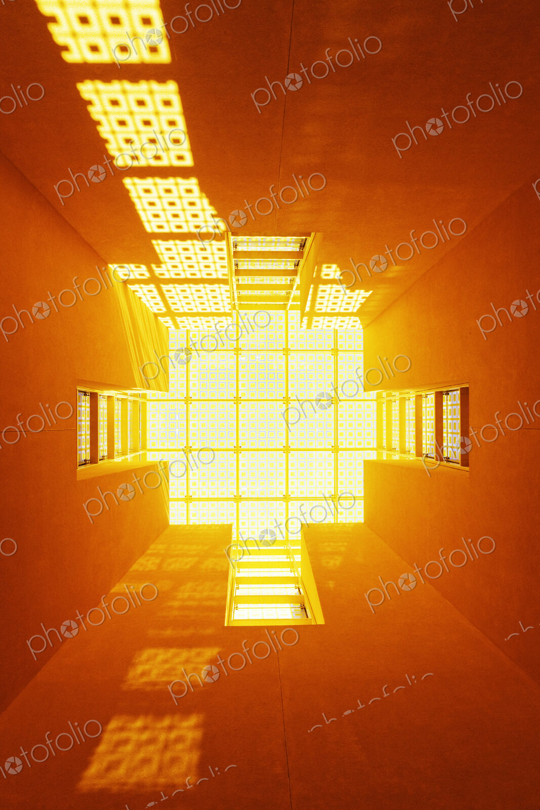 Low angle view of orange light in a lightwell of a building.