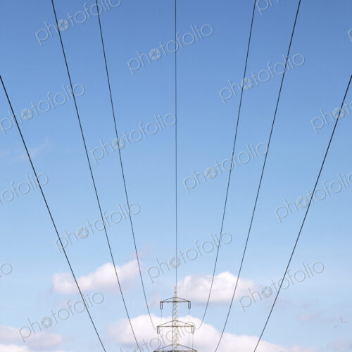 Low angle view of power lines under blue sky Low angle view of power lines under blue sky
