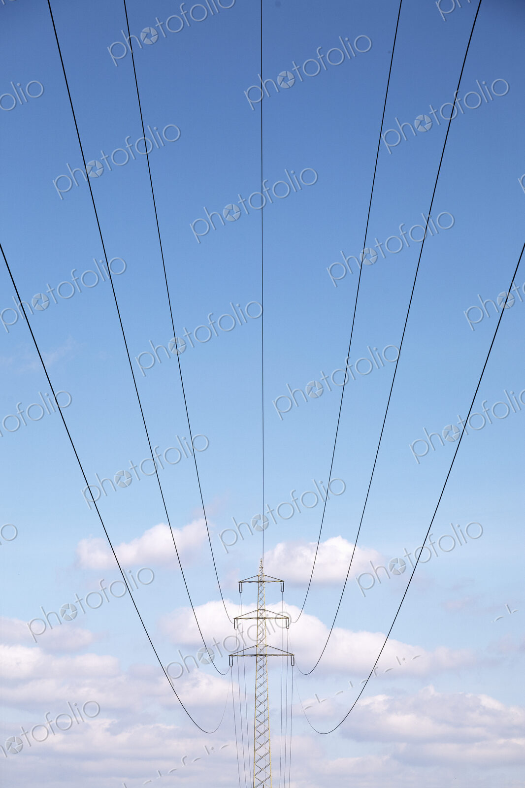 Low angle view of power lines under blue sky