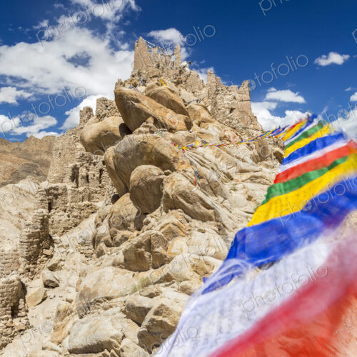 Low angle view of rock-face with colourful prayer flags. Low angle view of rock-face with colourful prayer flags.