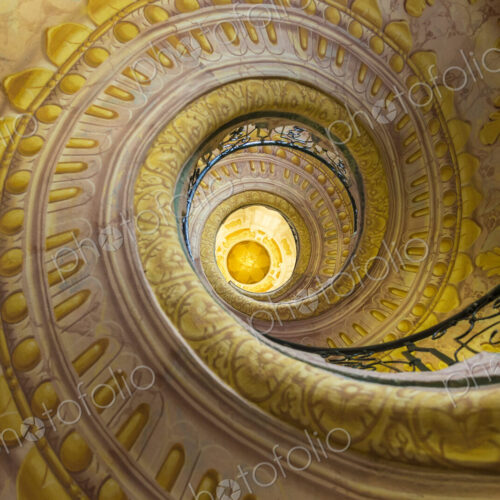 Low angle view of spiral staircase decorated with murals of golden Acanthus flowers… Low angle view of spiral staircase decorated with murals of golden Acanthus flowers…