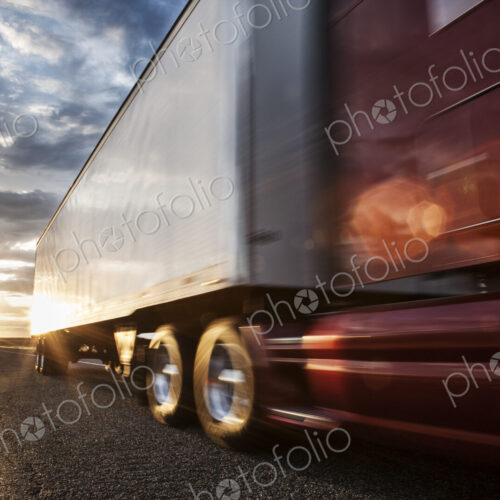 Low angle view of the cab and trailer on a Class 8 commercial truck on the highway at… Low angle view of the cab and trailer on a Class 8 commercial truck on the highway at…
