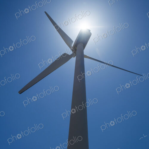 Low angle view of wind turbine and blue sky Low angle view of wind turbine and blue sky