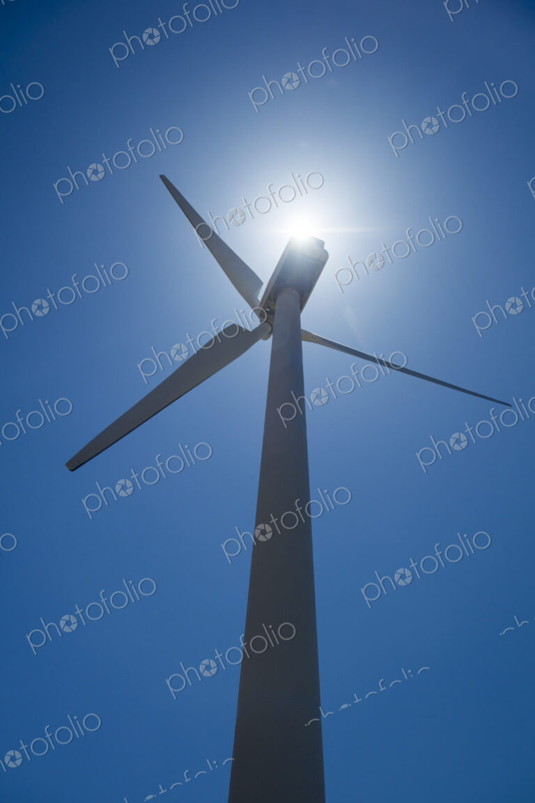 Low angle view of wind turbine and blue sky