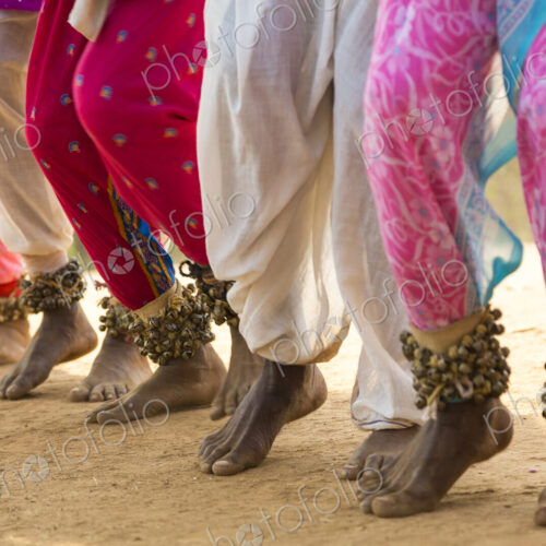 Low section view of barefoot dancers in a row on a street, wearing pink trousers and… Low section view of barefoot dancers in a row on a street, wearing pink trousers and…