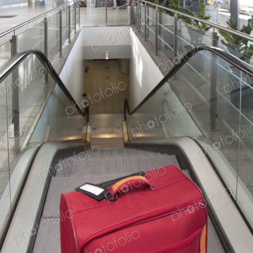 Luggage at the Top of an Escalator