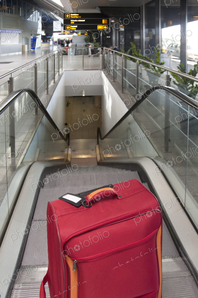 Luggage at the Top of an Escalator