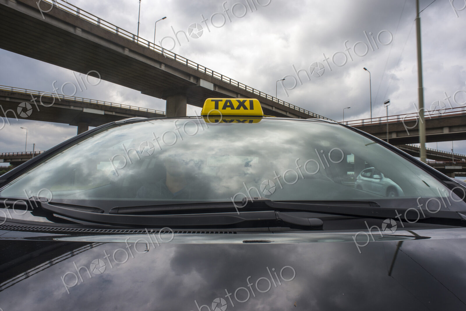 Luxurious car with a taxi sign on its roof.