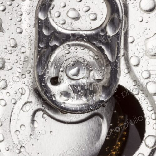 Macro image of an open aluminum can with water droplets on the surface. Refreshing,…