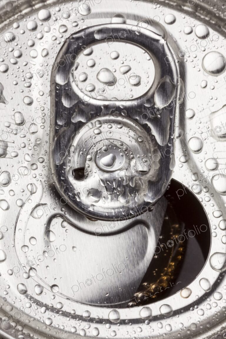Macro image of an open aluminum can with water droplets on the surface. Refreshing,…