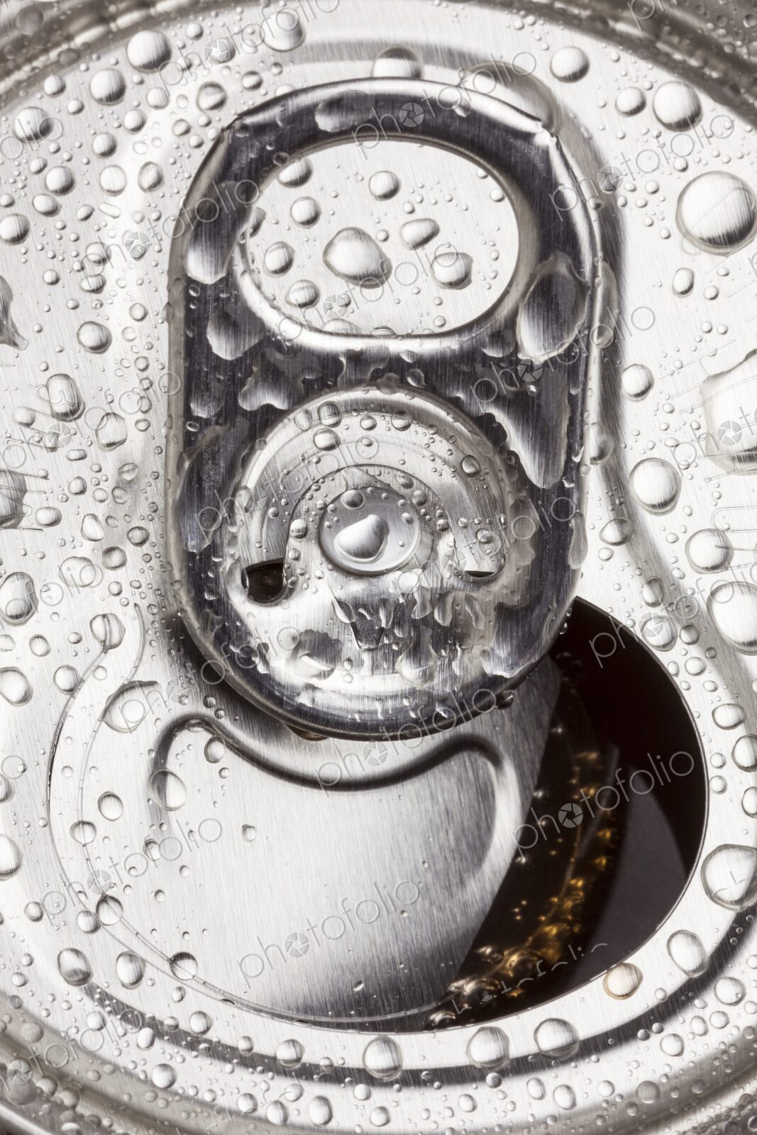 Macro image of an open aluminum can with water droplets on the surface. Refreshing,…