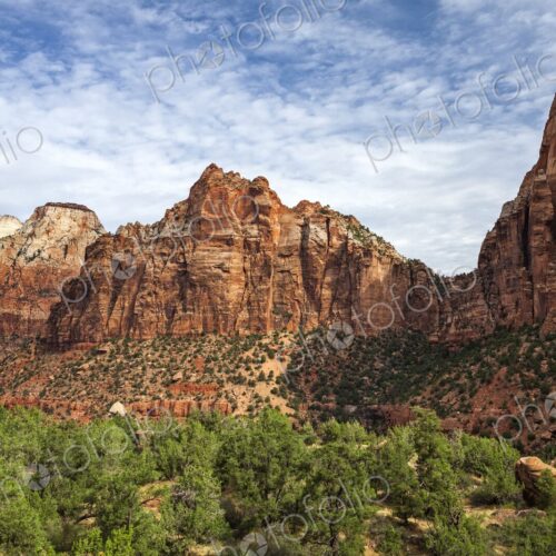 Majestic red rock cliffs rise above a lush green canyon in Zion National Park, Utah,… Majestic red rock cliffs rise above a lush green canyon in Zion National Park, Utah,…