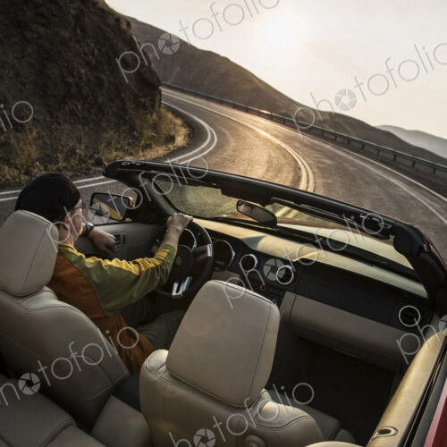 Male driver in a convertible sports car driving on the highway Male driver in a convertible sports car driving on the highway