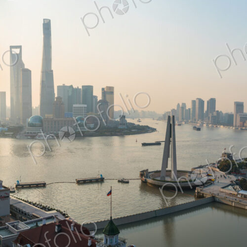 Man admiring view over Huangpu River & Shanghai skyline in early morning, Shanghai, China Man admiring view over Huangpu River & Shanghai skyline in early morning, Shanghai, China