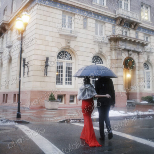 Man and woman, couple in evening dress outside in a city