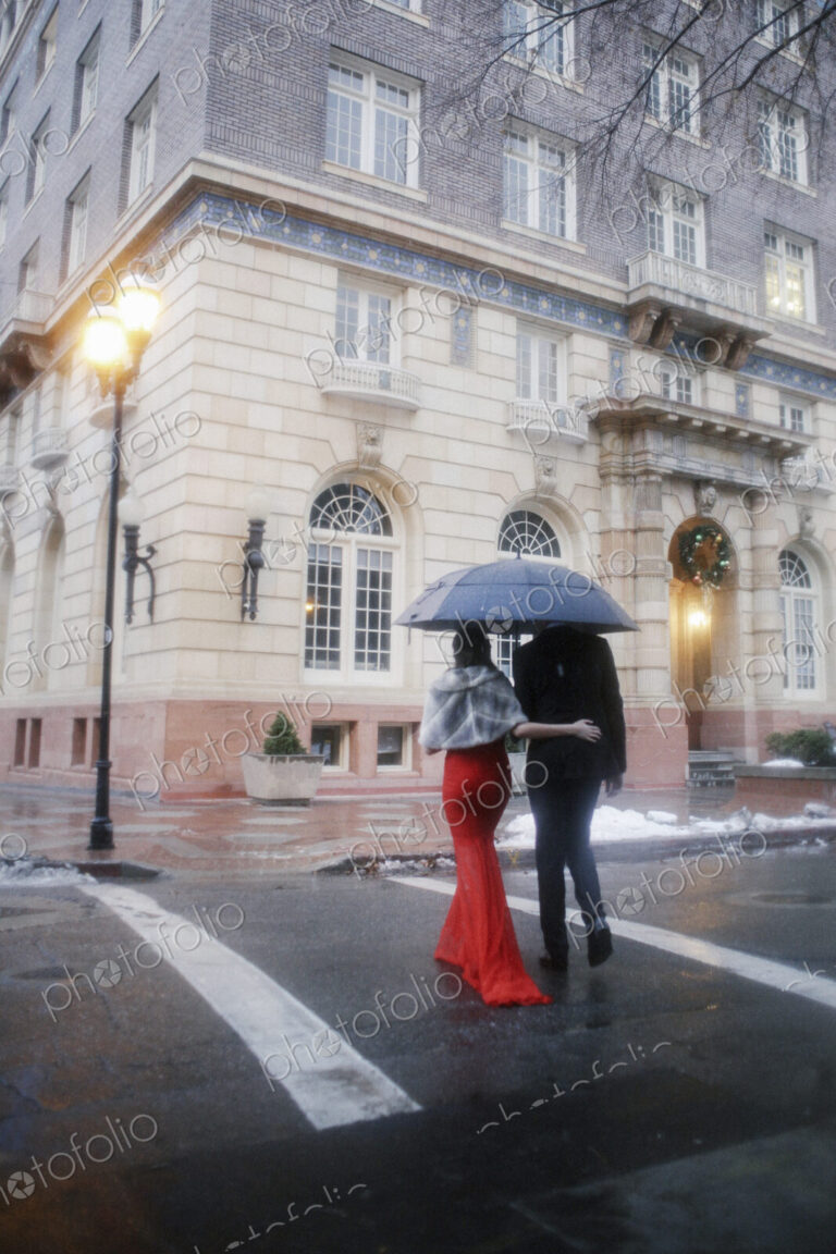 Man and woman, couple in evening dress outside in a city
