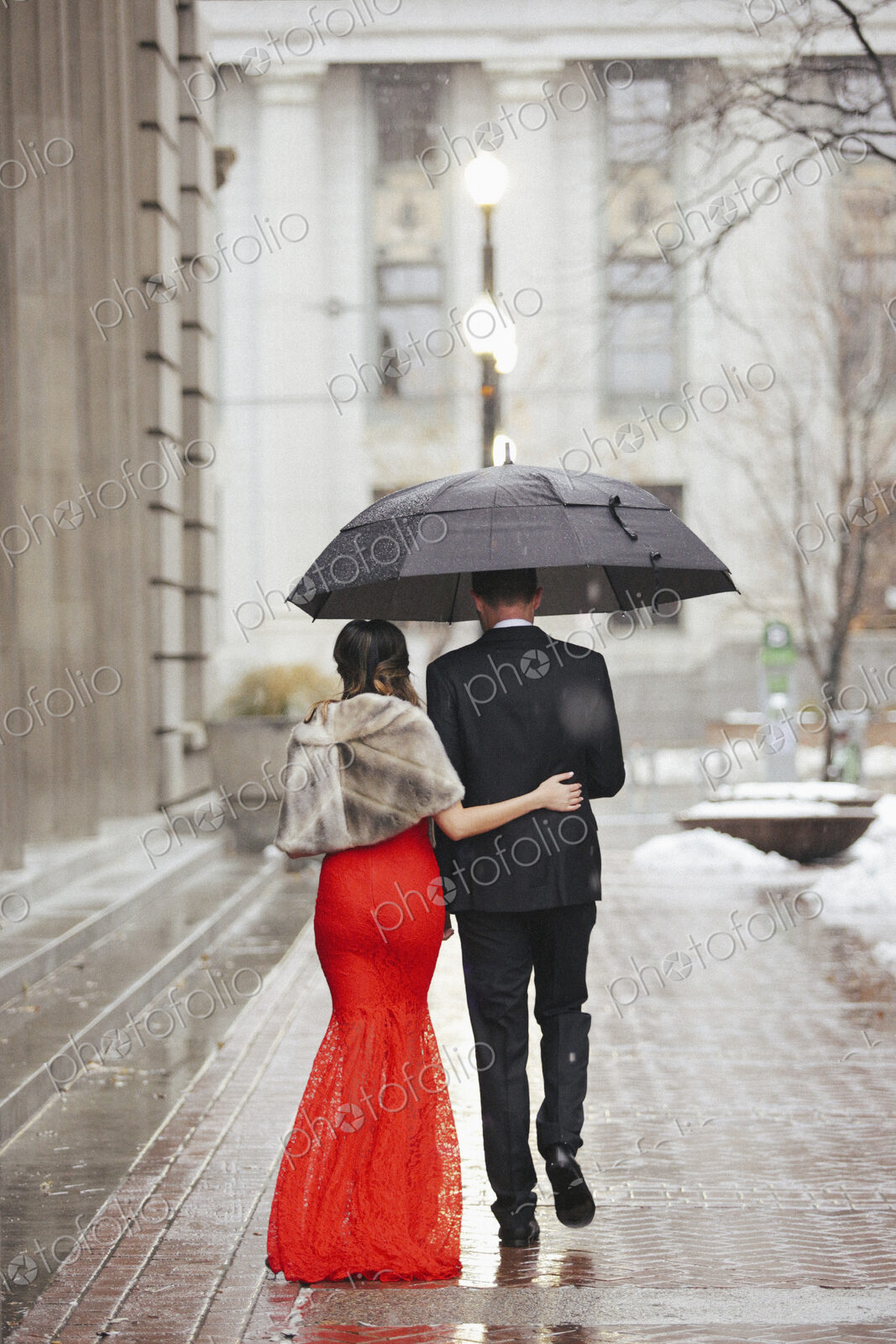 Man and woman, couple in evening dress outside in a city