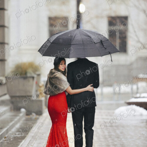 Man and woman, couple in evening dress outside in a city