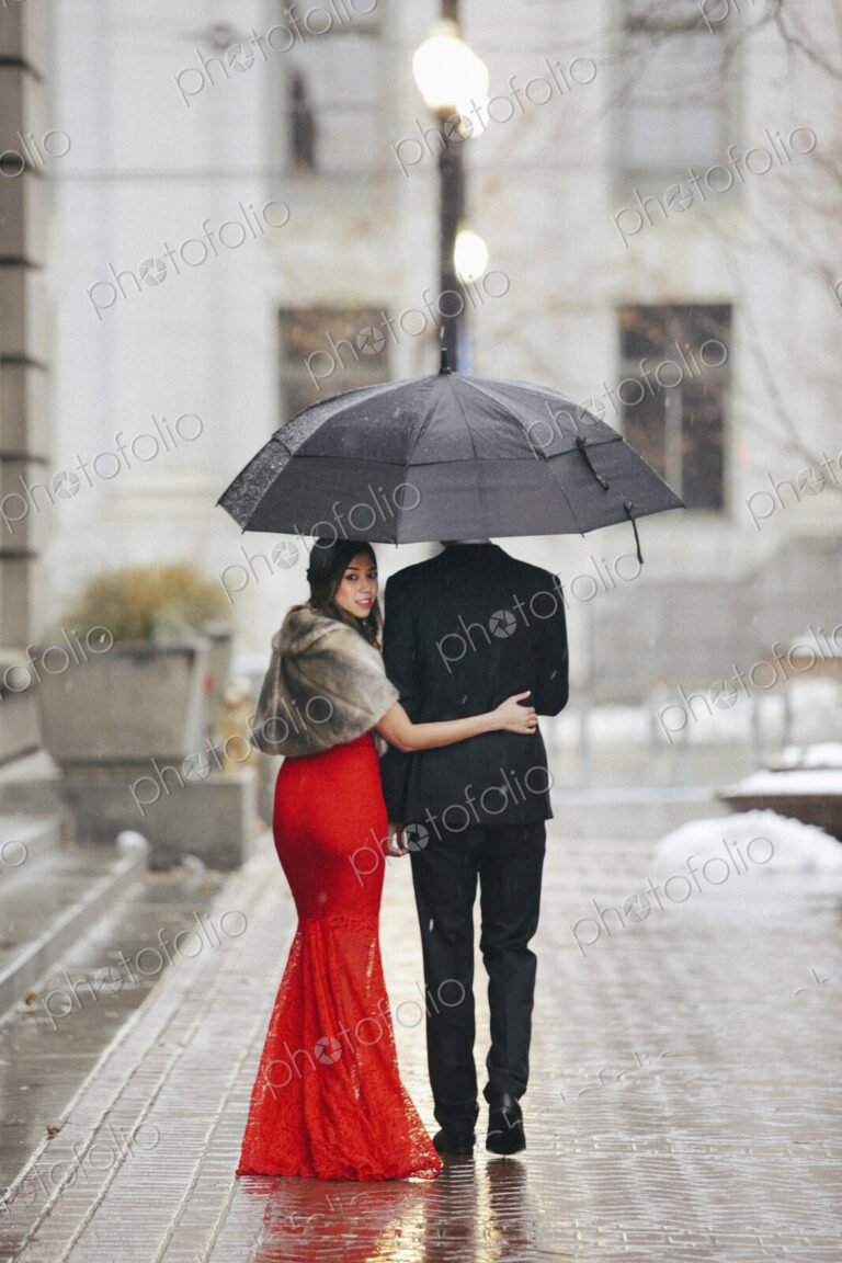 Man and woman, couple in evening dress outside in a city
