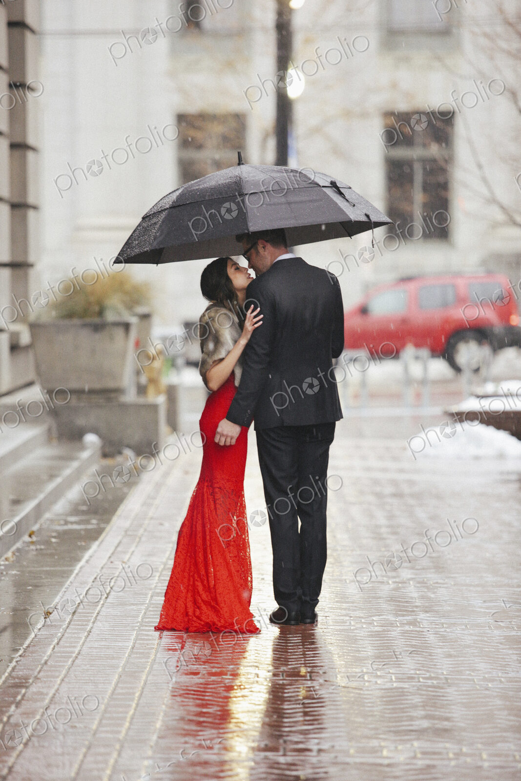 Man and woman, couple in evening dress outside in a city
